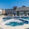 One Bedroom Apartments in Boise, ID - The Timbers at Harris Ranch - Pool with Jacuzzi, Lounge Chairs, and Umbrellas. 